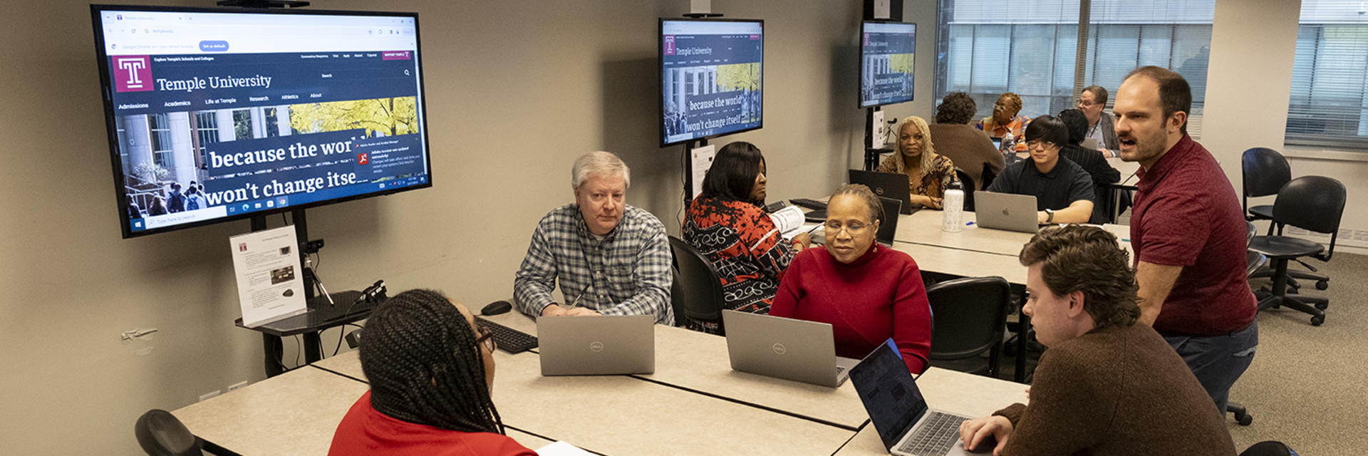 people sitting at a computer lab